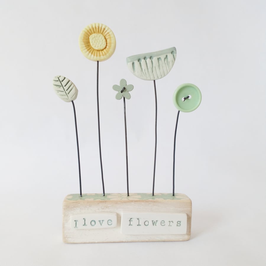 Clay and button flower garden in a painted wood block 'I love flowers'