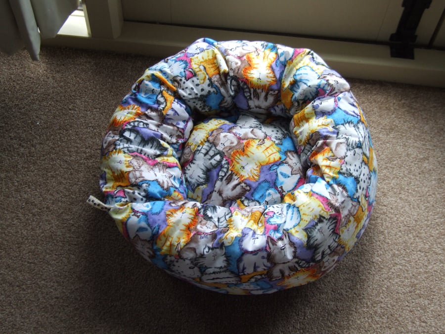 Lovely soft bed for cat or small dog printed with cartoon cats and dogs.