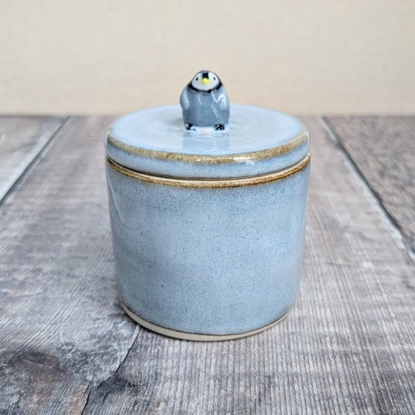 Small ceramic lidded blue pot with mini penguin