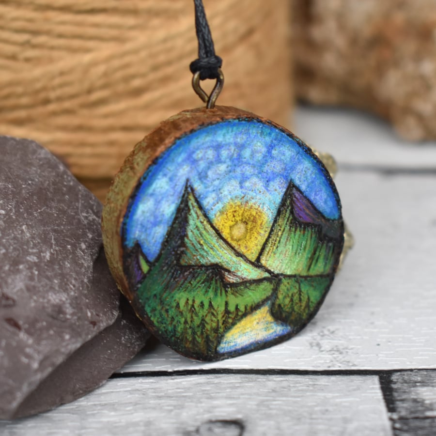 Sunrise over the mountains & rivers pyrography wood branch pendant.