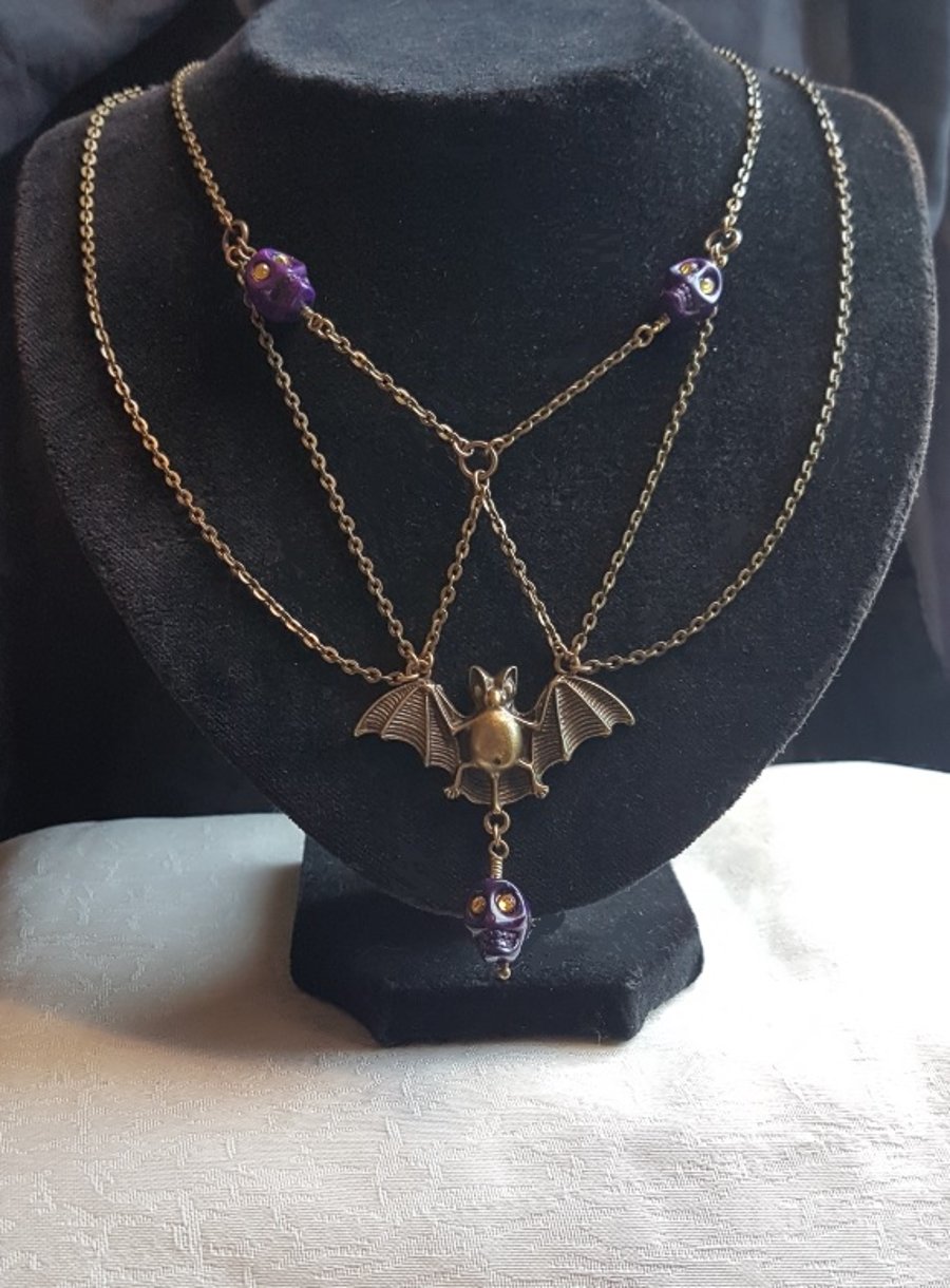 Spooky Antique Bronze Bat Necklace with Purple Skulls.