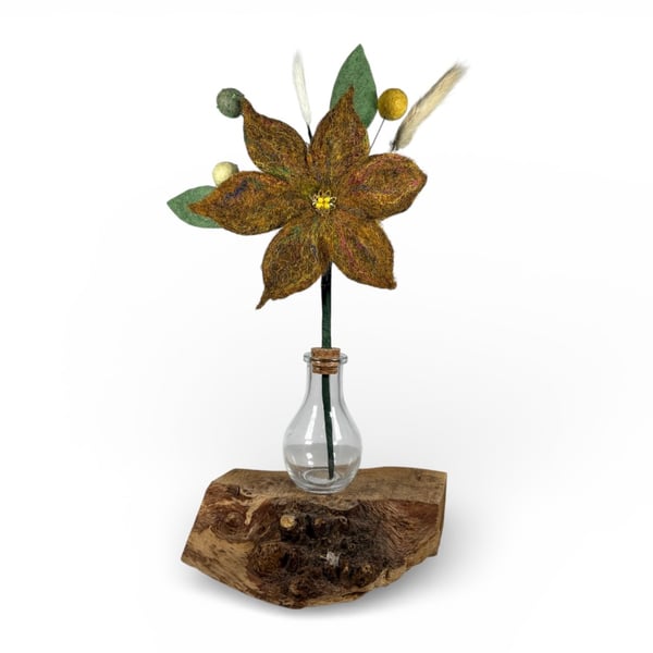 Orange felted flower arrangement in glass bottle vase