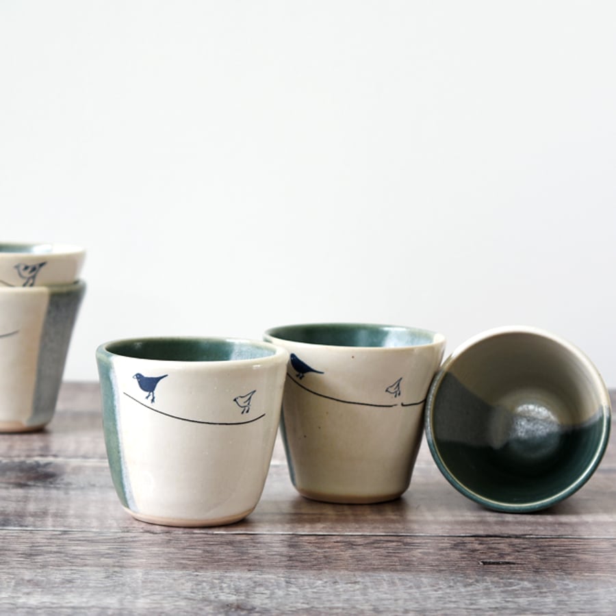 Handmade green and white ceramic tumbler beaker cup with garden birds
