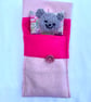 Hand knitted comfort bear in a bed