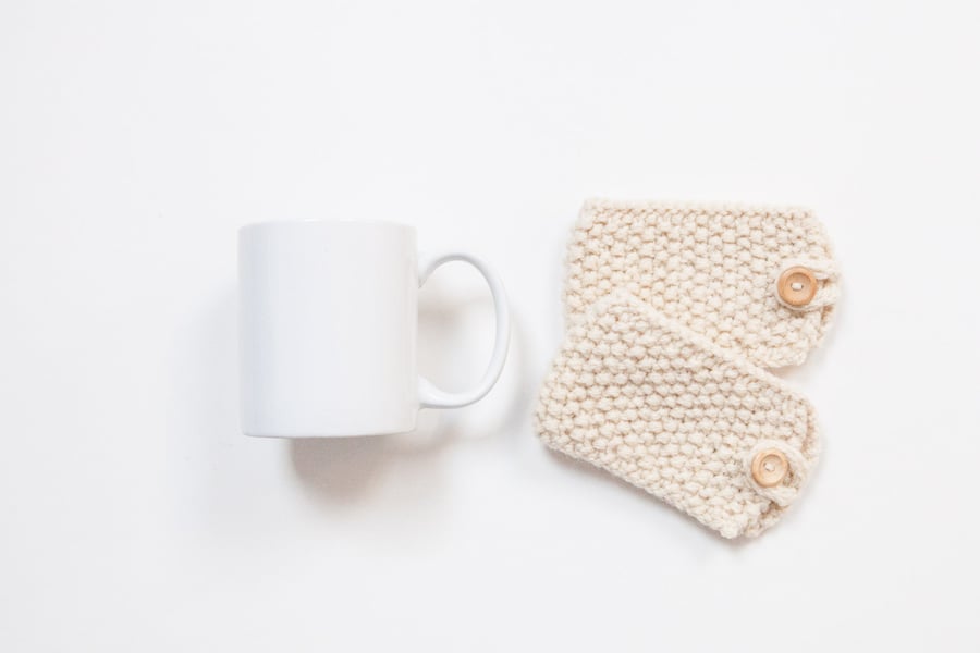 Pair of knitted mug cosies, cup cosy, coffee cosy in Cream. Coffee mug cosy