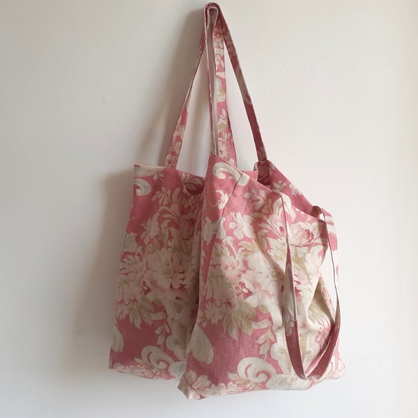 Tote bag upcycled in a washed and faded vintage floral print with foldaway pouch
