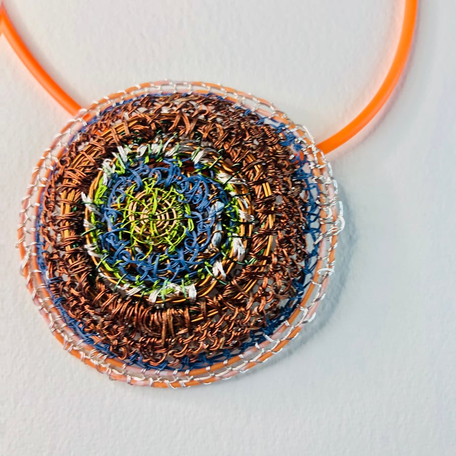 Disc pendant from recycled and found materials