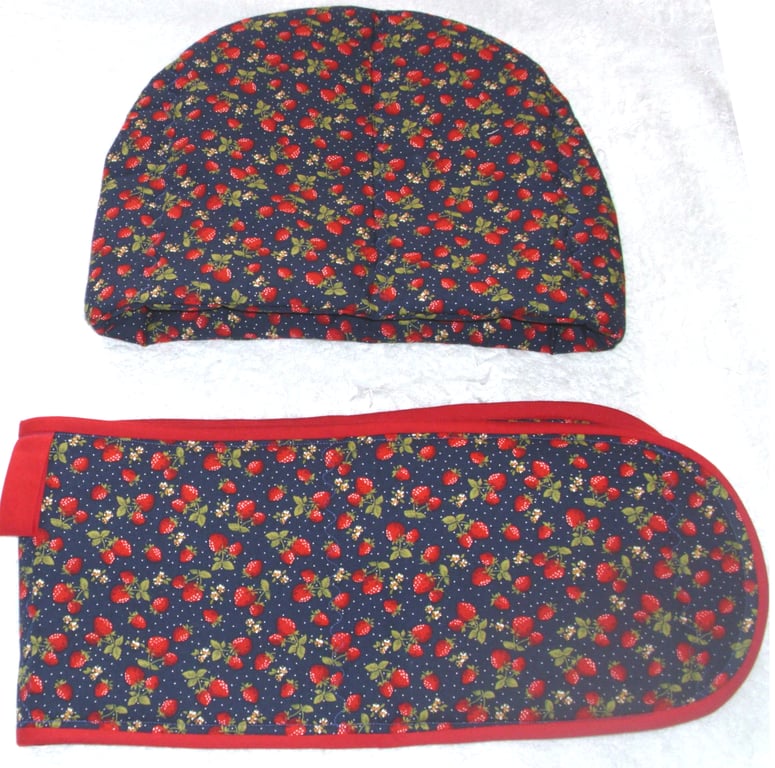Juicy red strawberries on blue tea cosy and ovengloves
