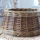 A round handmade willow basket with tapered sides