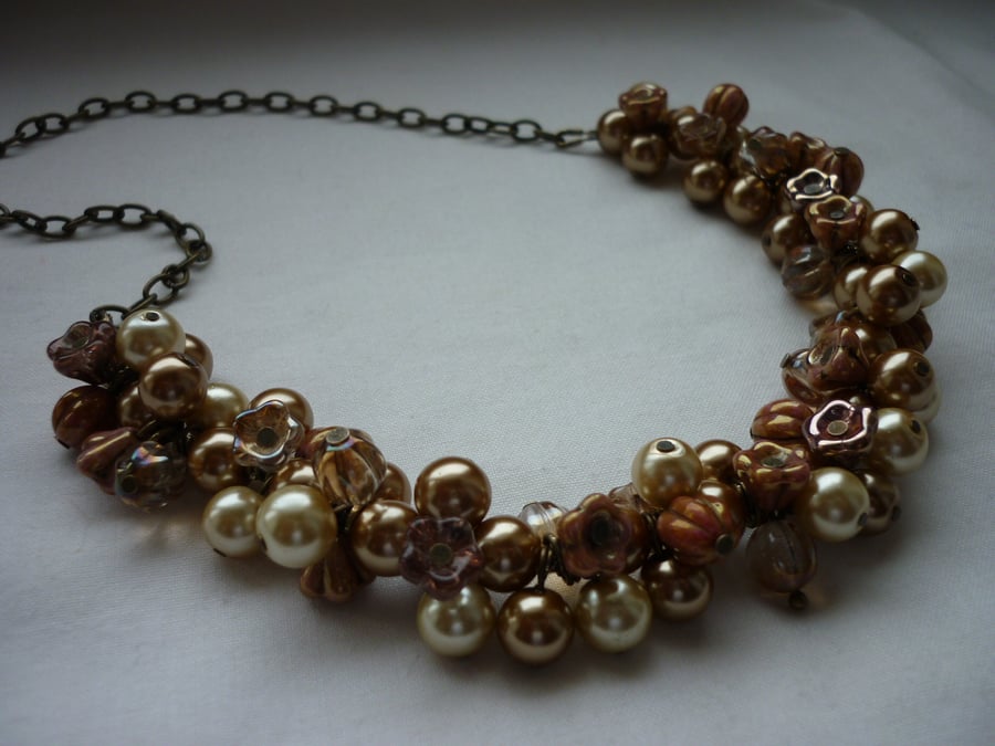 SHADES OF CREAM, GOLDS AND BRONZE CLUSTER NECKLACE.  463
