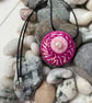 Hand embroidered circular pendant in shades of pink