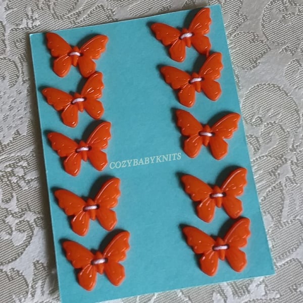 Orange butterfly plastic buttons