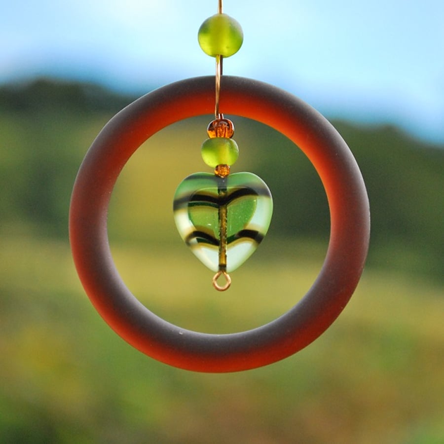 Brown glass pendant with olive green heart