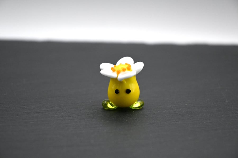 yellow glass flower hear figure