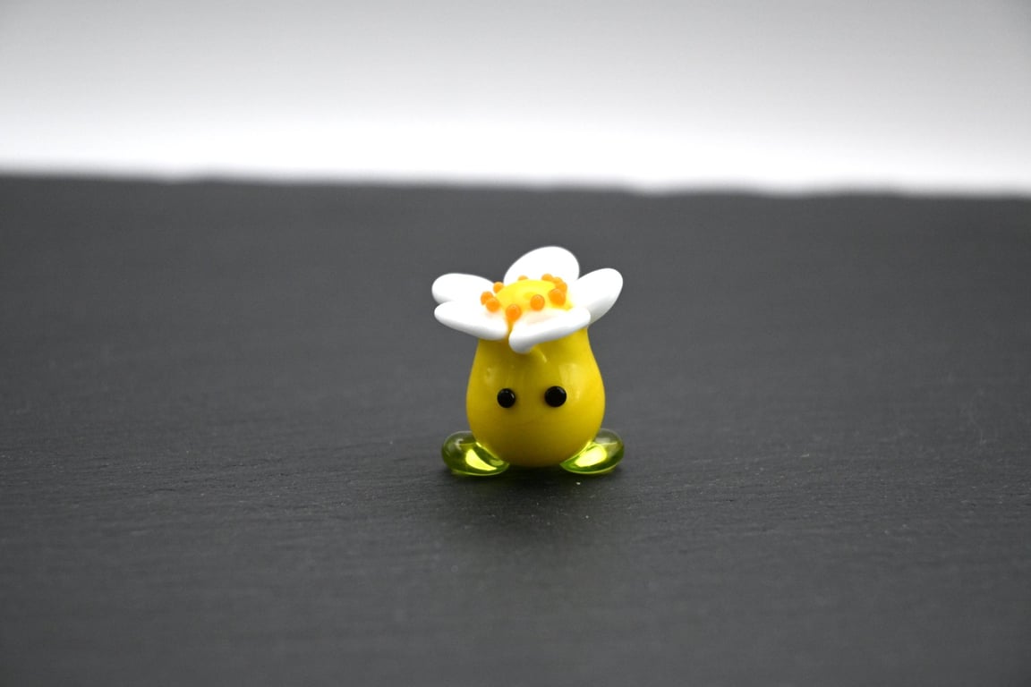 yellow glass flower hear figure