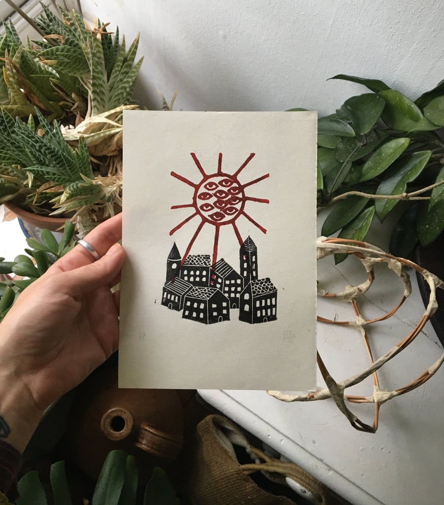 Zenith, folk linocut print village and sun on paper
