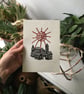 Zenith, folk linocut print village and sun on paper