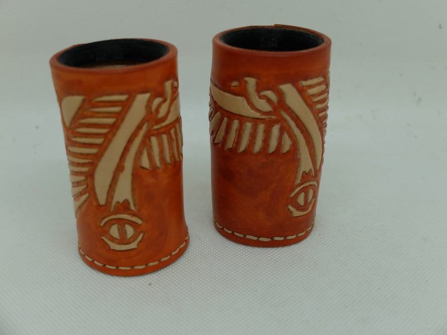 Pair of hand carved and tooled leather dice cups in orange