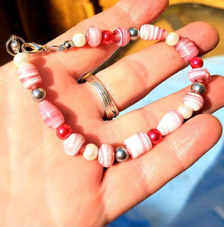 Pink and white shell like beads with red, pearl and silver spacers bracelet