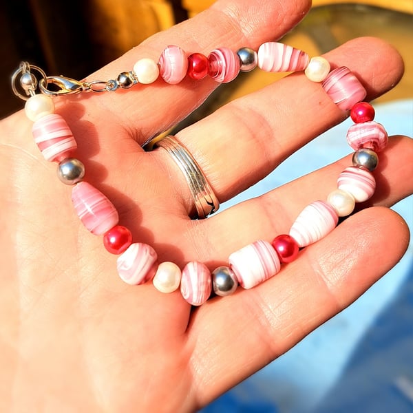 Pink and white shell like beads with red, pearl and silver spacers bracelet