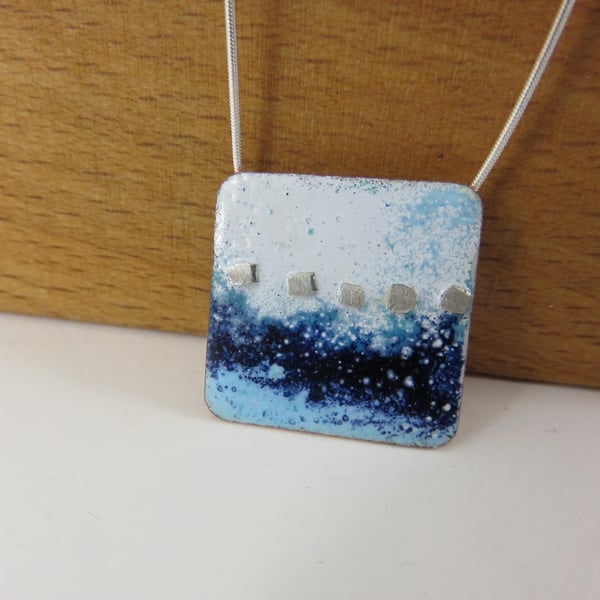 Square copper necklace pendant with blue and white enamel and silver peg detail.