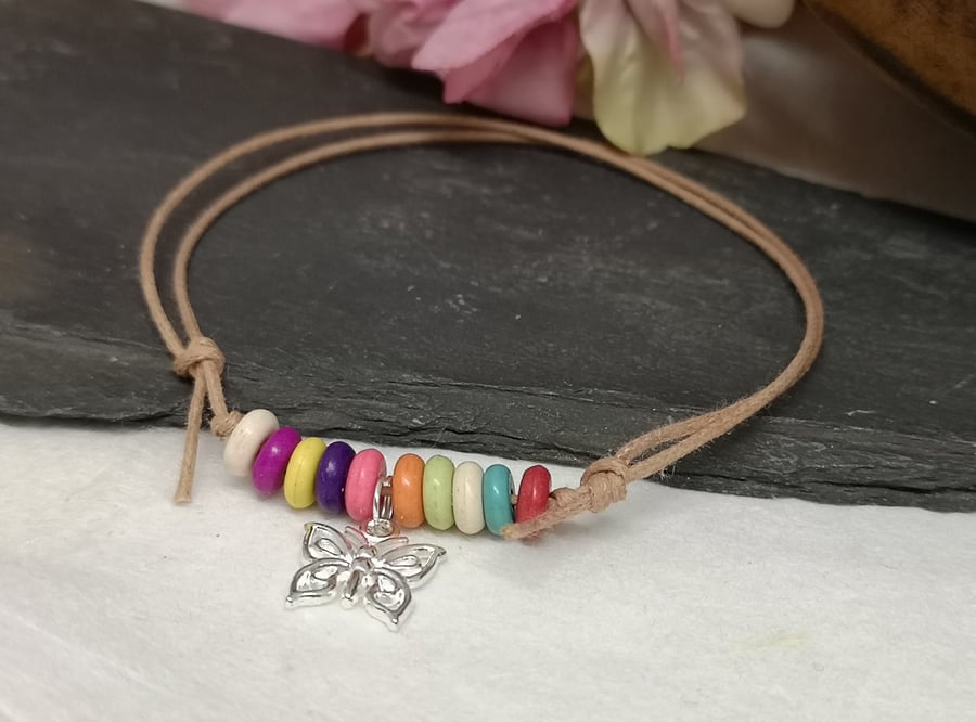 Adjustable cotton cord anklet with rainbow howlite beads and a butterfly charm 