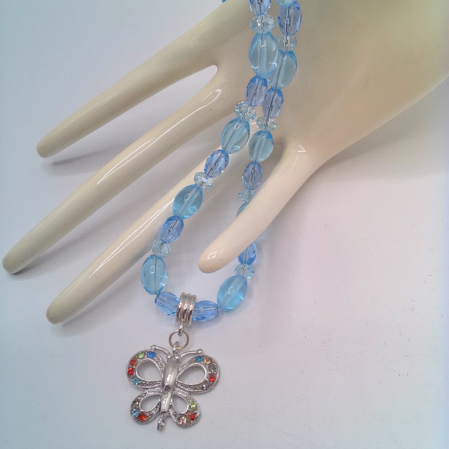 Multi Colour Rhinestone Butterfly Pendant on a Blue Bead and Crystal Necklace
