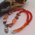 Silver Skull Pendant on an Orange Red Purple & Pink Shell Beaded Necklace