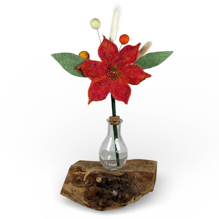 Orange felted flower arrangement in glass bottle vase