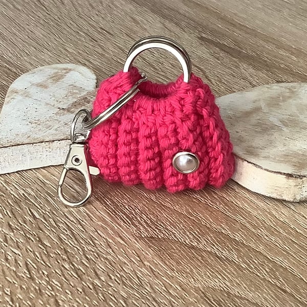 Small bag key, ear buds, spare coins holder.