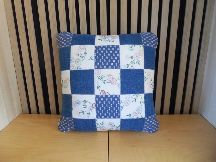 Patchwork cushion made with denim and reclaimed vintage embroidery