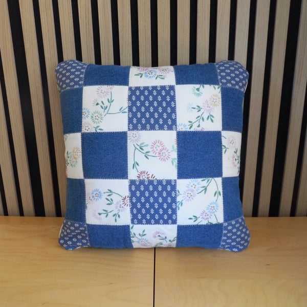 Patchwork cushion made with denim and reclaimed vintage embroidery