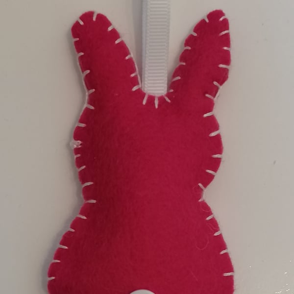 Handmade pink felt rabbit with white stitching, ribbon and button 