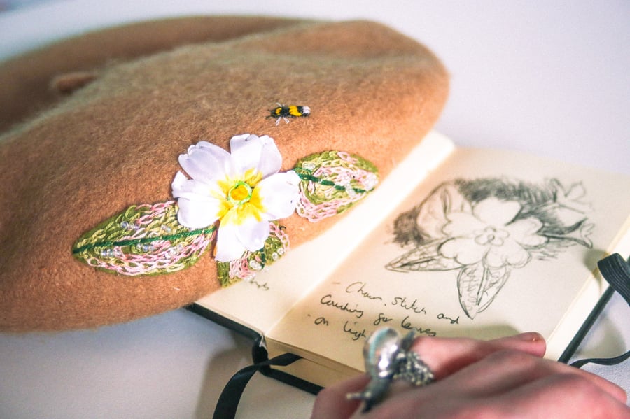 Hand embroidered primrose and bee on a camel new wool beret 
