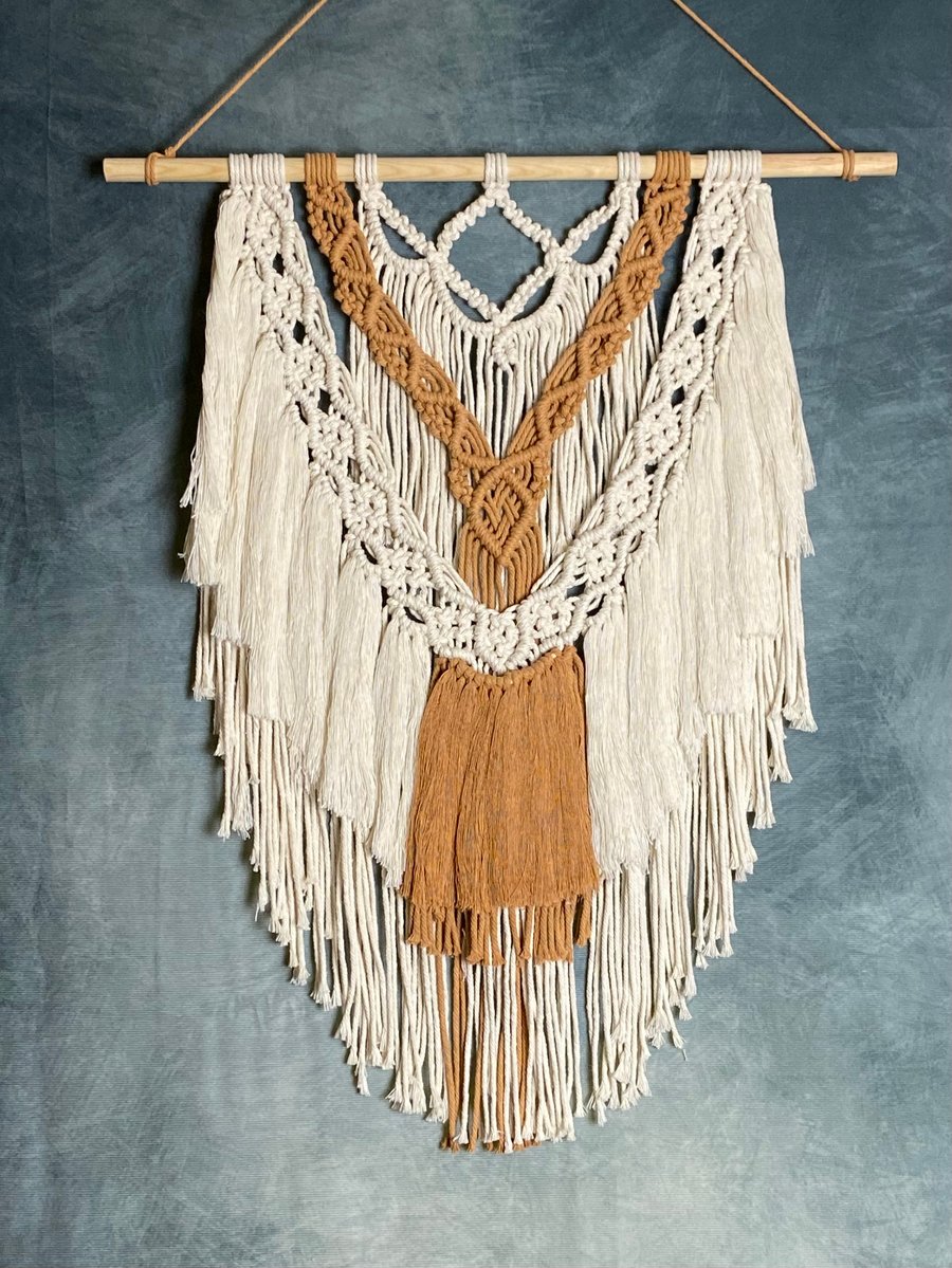 Macrame wall hanging with intricate knot design, caramel and beige colours