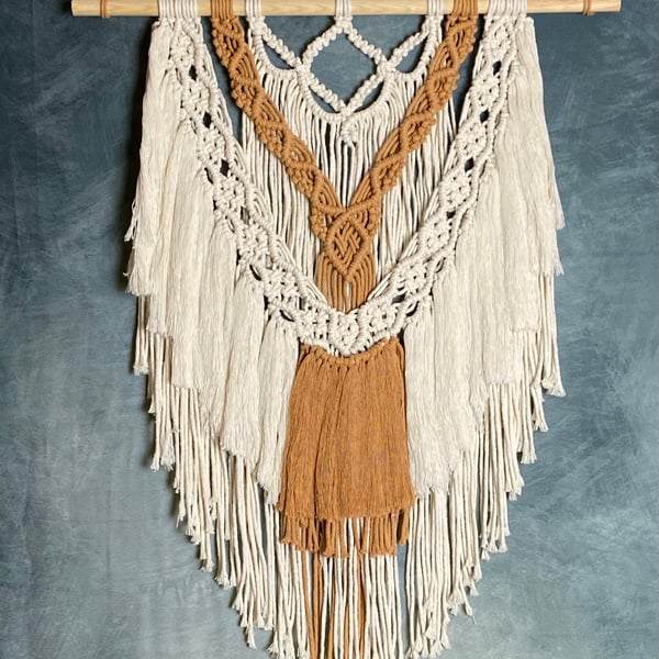 Macrame wall hanging with intricate knot design, caramel and beige colours