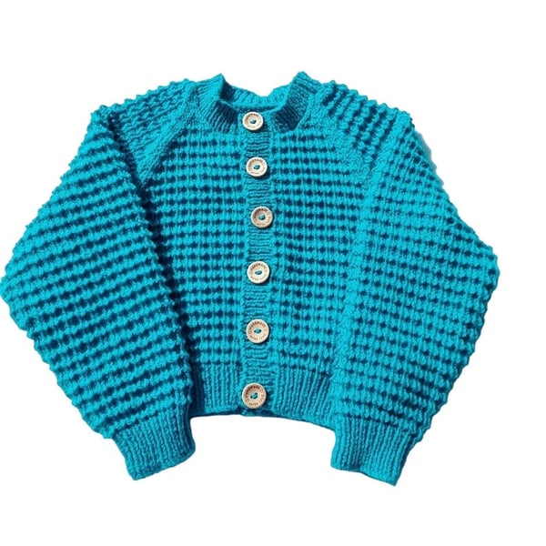 Hand knitted baby cardigan in turquoise with textured pattern 