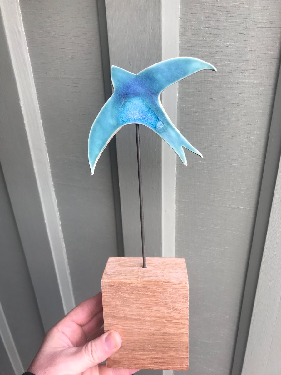 Single Swift - (No 2) A turquoise ceramic swift mounted on a wooden block