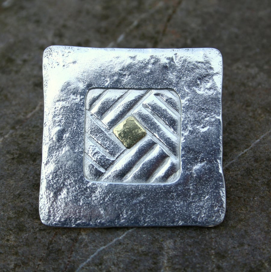 Silver and gold square brooch.