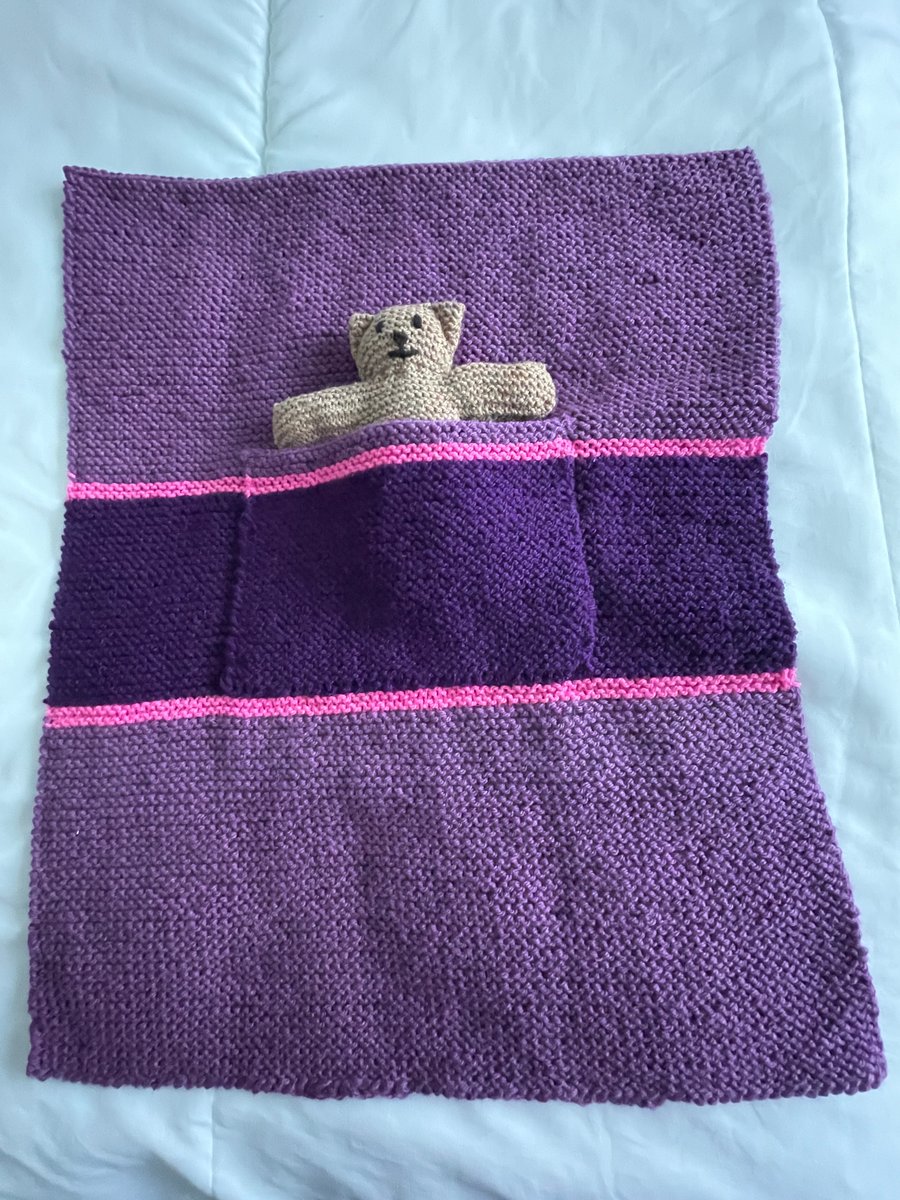 Hand knitted blanket with Teddy in the pocket