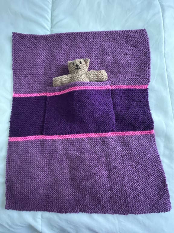 Hand knitted blanket with Teddy in the pocket