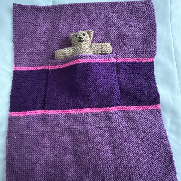 Hand knitted blanket with Teddy in the pocket