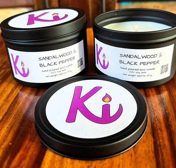Sandalwood & Black Pepper scented soy candle in a black tin