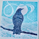 A freshly printed linocut card featuring a starling gazing at the moon