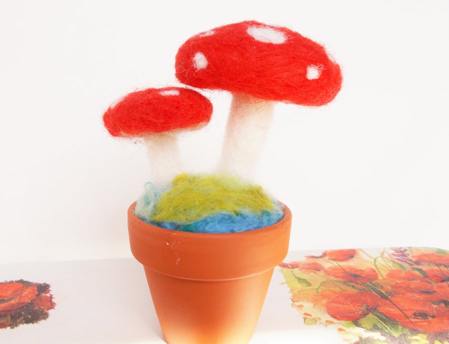 Felted toadstools in terracotta pot 