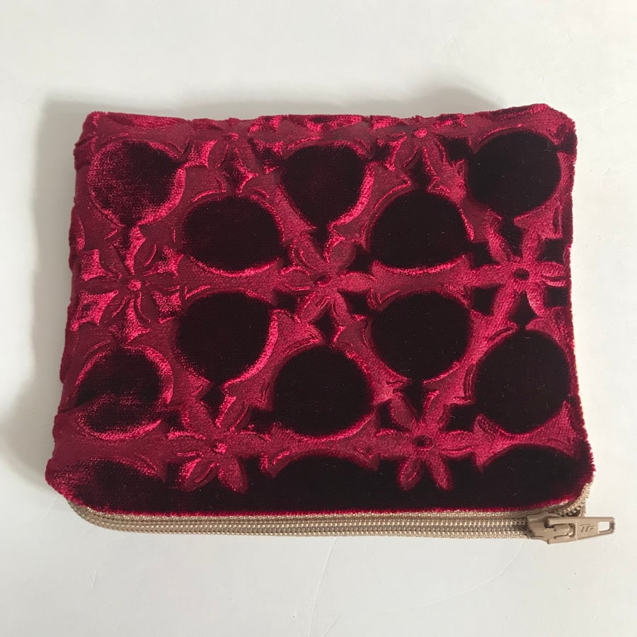 Burgundy small purse with embossed velvet floral and linen design and zip top . 