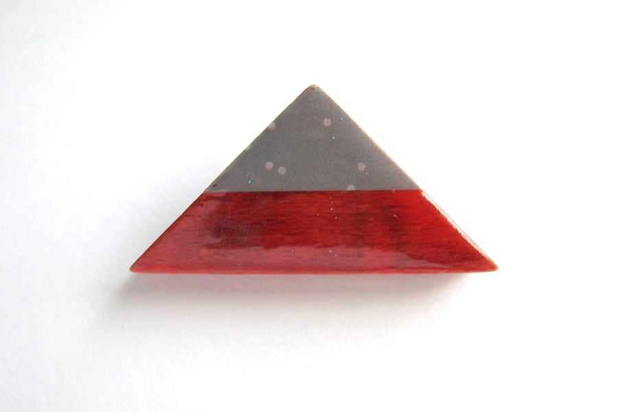 Red triangle brooch