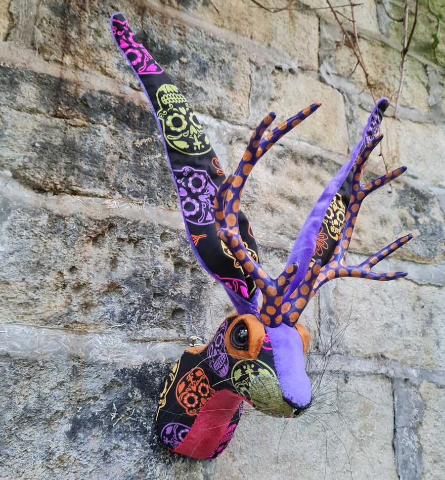 Faux jackalope head wall mount in Day of the Dead skull style fabric