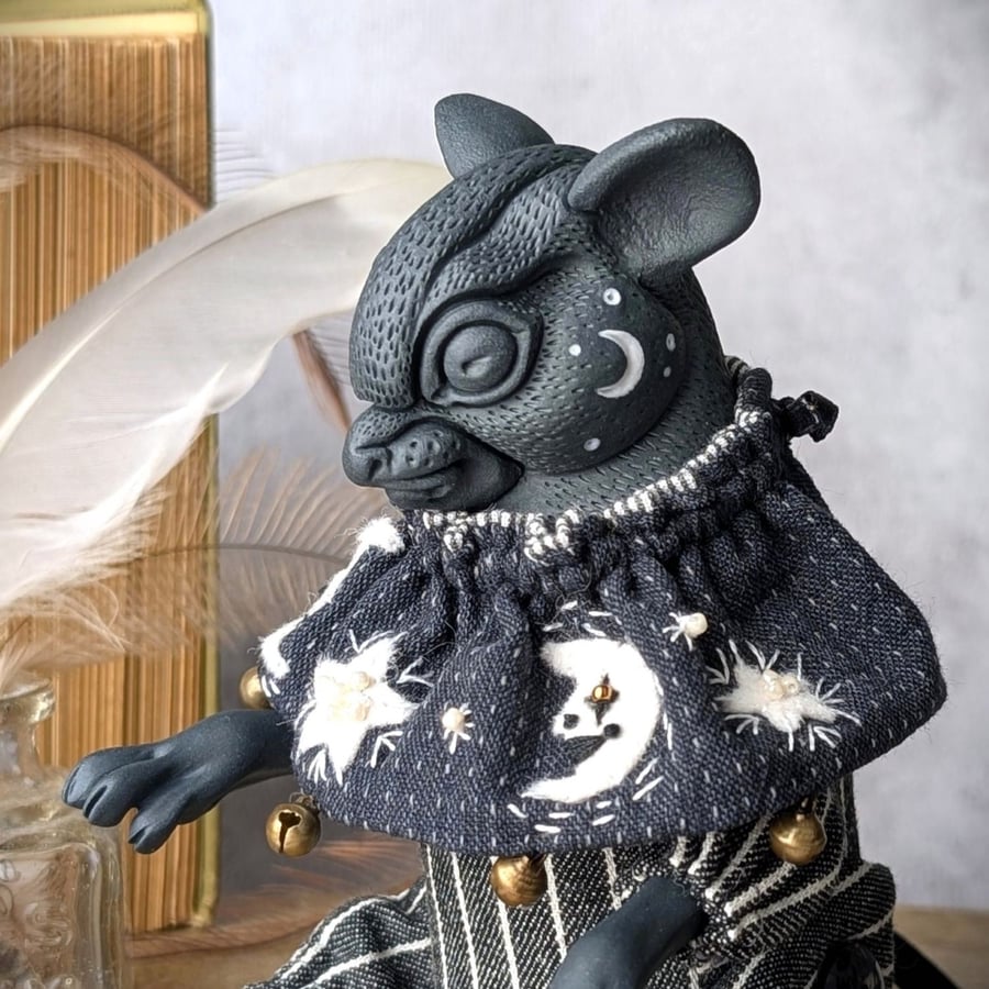 'Lumen', a black porcelain and textile mouse imp.