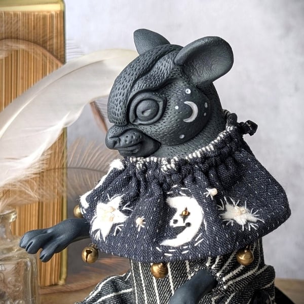 'Lumen', a black porcelain and textile mouse imp.